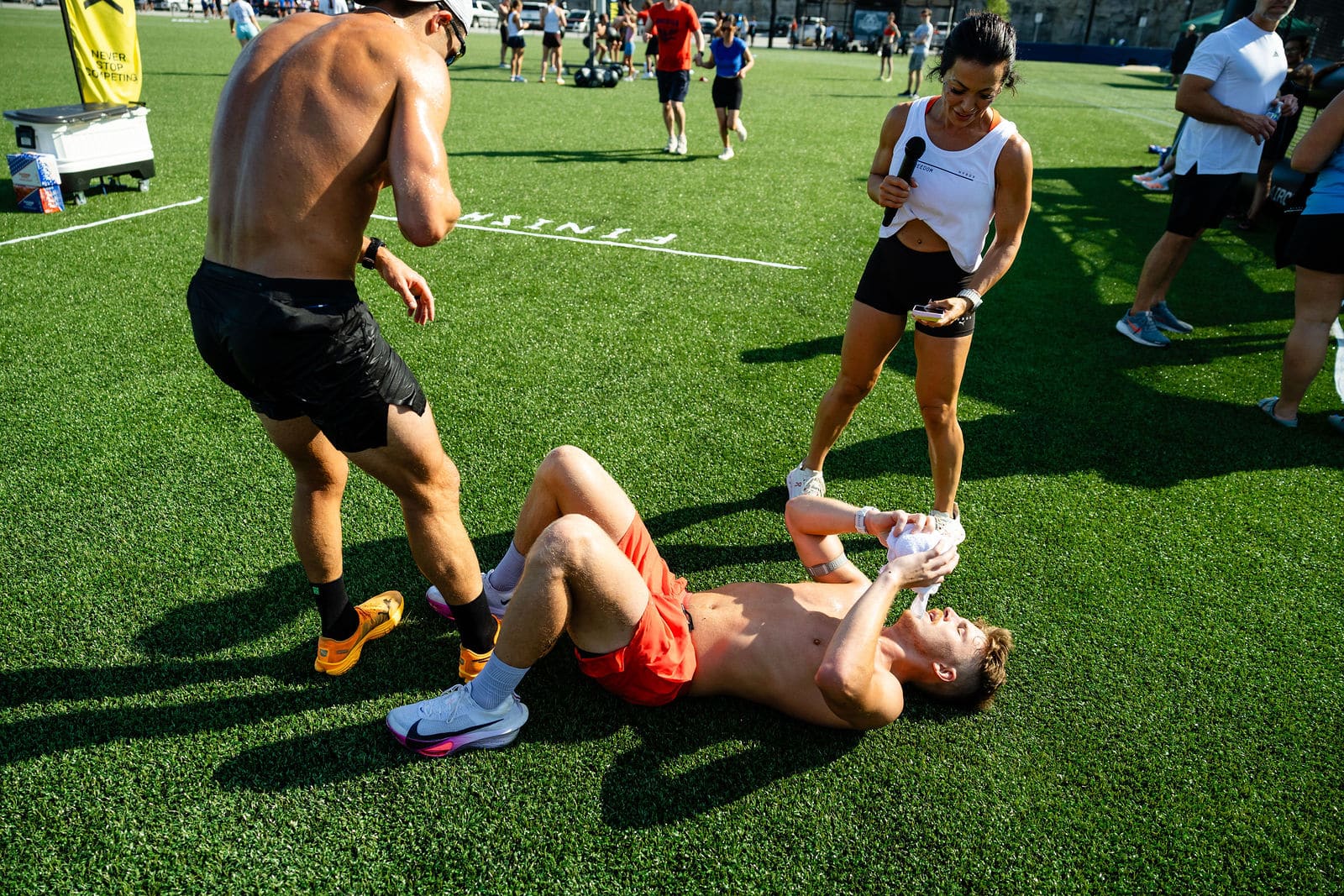 Teammates helping an athlete who left it all on the field